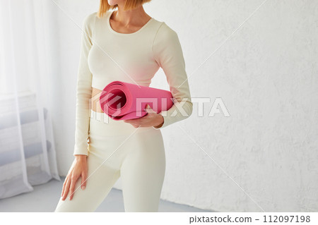 Young sporty smiling woman posing with yoga mat after yoga class. Yoga coach, yoga teacher.Young sporty smiling woman posing with yoga mat after yoga class. Yoga coach, yoga teacher. Young sporty smiling woman posing with yoga mat after yoga class. Yoga coach, yoga teacher.Young sporty smiling woman posing with yoga mat after yoga class. Yoga coach, yoga teacher. 112097198