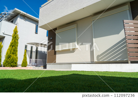A house with a garden with artificial turf A house with a garden with artificial turf 112097236