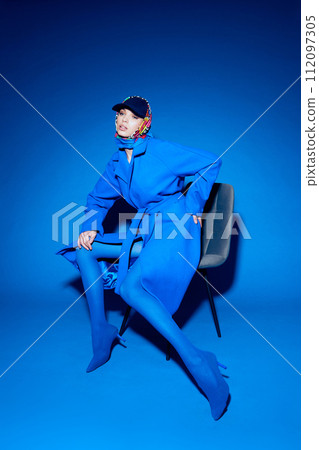 fashion portrait of young elegant woman in blue coat. 112097305