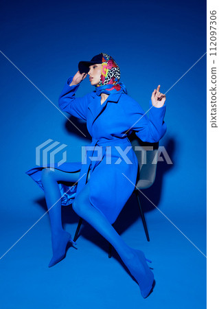 fashion portrait of young elegant woman in blue coat. fashion portrait of young elegant woman in blue coat. 112097306