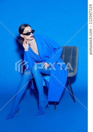 fashion portrait of young elegant woman in blue coat. 112097329