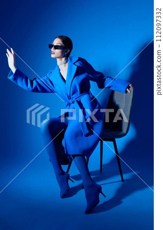 fashion portrait of young elegant woman in blue coat. fashion portrait of young elegant woman in blue coat. 112097332