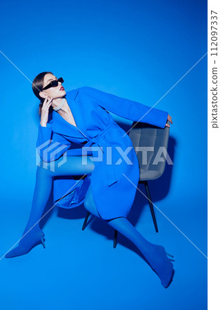 fashion portrait of young elegant woman in blue coat. 112097337