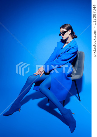 fashion portrait of young elegant woman in blue coat. fashion portrait of young elegant woman in blue coat. 112097344