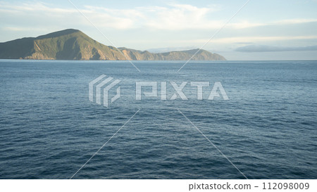 View on hilly landscape from passing transport boat during its sail, New Zealand View on hilly landscape from passing transport boat during its sail, New Zealand 112098009