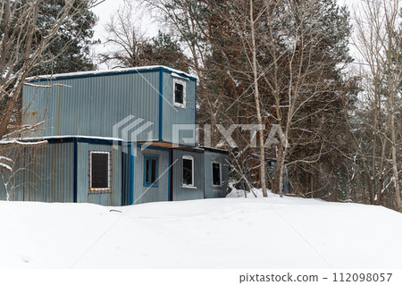 Construction trailer with windows on snow-covered site, shift housing Construction trailer with windows on snow-covered site, shift housing 112098057