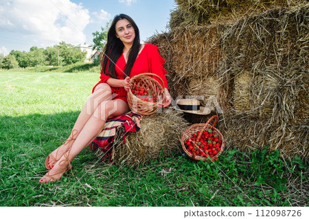 Portrait of Smiling Woman with Basket of Strawberries 112098726
