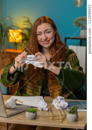 Angry furious businesswoman throwing crumpled paper nervous breakdown at office work losing temper 112098851