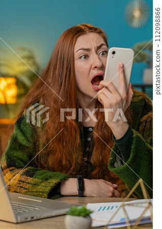 Nervous stressed woman manager quarrelling smartphone call online talking aggressively at office Nervous stressed woman manager quarrelling smartphone call online talking aggressively at office 112098866