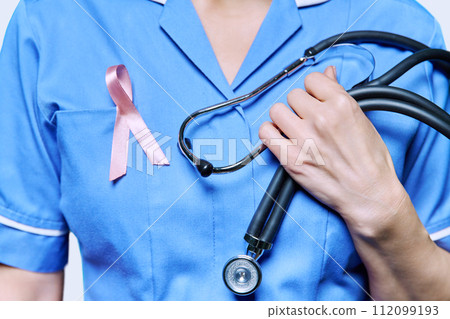 Close-up female nurse with with stethoscope, pink ribbon Close-up female nurse with with stethoscope, pink ribbon 112099193
