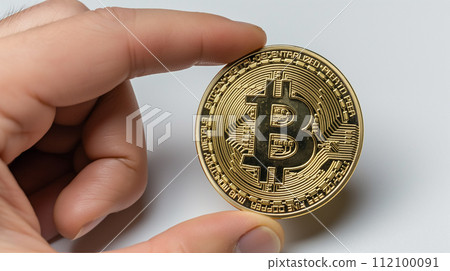 Close hand clutches coins, symbolizing savings, wealth, or financial concept Close hand clutches coins, symbolizing savings, wealth, or financial concept 112100091
