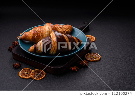 Delicious fresh, crispy French croissants with sweet filling Delicious fresh, crispy French croissants with sweet filling 112100274