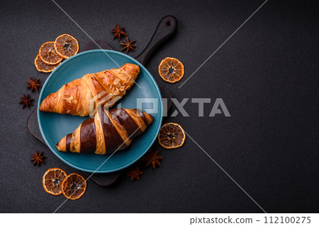 Delicious fresh, crispy French croissants with sweet filling Delicious fresh, crispy French croissants with sweet filling 112100275
