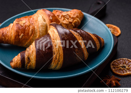 Delicious fresh, crispy French croissants with sweet filling  112100279