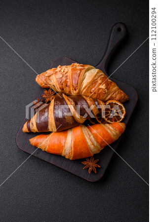Delicious fresh, crispy French croissants with sweet filling  112100294