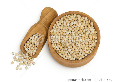Sorghum seeds in wooden bowl and scoop isolated on white background. Top view. Flat lay. Sorghum seeds in wooden bowl and scoop isolated on white background. Top view. Flat lay. 112100579