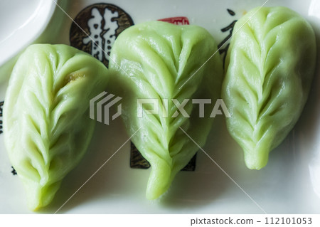 Top view of green japanese dumplings Gyoza with vegetables close up Top view of green japanese dumplings Gyoza with vegetables close up 112101053