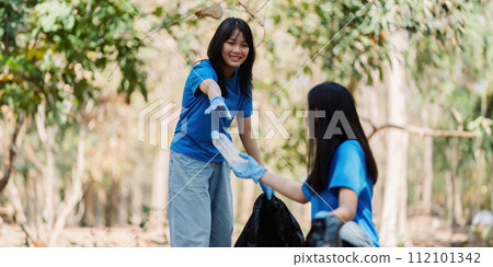 Group of volunteers, community members cleaning the nature from garbage and plastic waste to send it for recycling 112101342