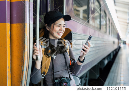 Woman using mobile phone while travel by train. travel concept Woman using mobile phone while travel by train. travel concept 112101355