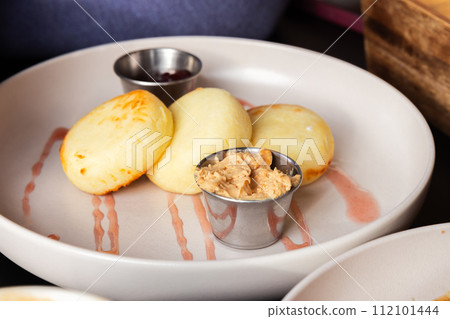 Slavic breakfast. Syrniki close up photo with selective soft focus 112101444