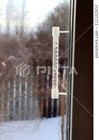 A plastic mercury or alcohol thermometer outside 112102652