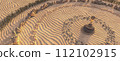 Desert Zen: Spiraling Stone Pathways in Sand at Golden Hour 112102915