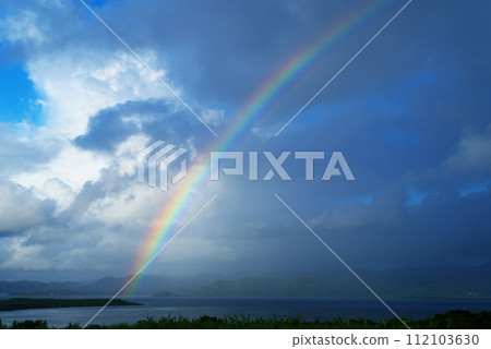 Rainbow over Iriomote Island on the opposite shore of Kohama Island, Okinawa Prefecture 112103630