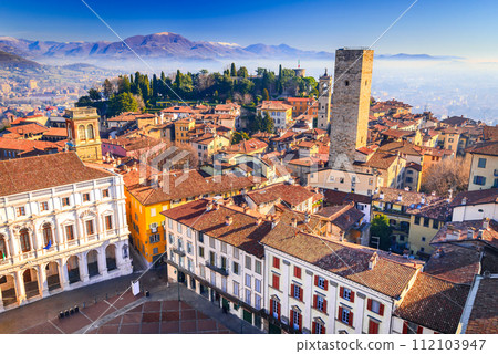 Bergamo, Lombardy - Italy. Upper view from Campanone with Piazza Vecchia and Torre del Gombito. 112103947