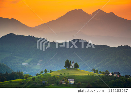 Sveti Tomaz, Slovenia. Church of Sveti Tomaz (Saint Thomas), Kamnik - Savinja Alps, beautiful colored sunrise sky. Sveti Tomaz, Slovenia. Church of Sveti Tomaz (Saint Thomas), Kamnik - Savinja Alps, beautiful colored sunrise sky. 112103987