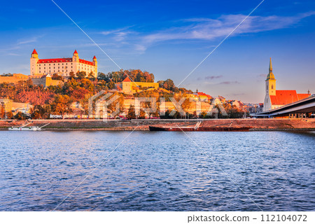 Bratislava, Slovakia. Bratislava Castle and old town over Danube River, sunrise light. Bratislava, Slovakia. Bratislava Castle and old town over Danube River, sunrise light. 112104072