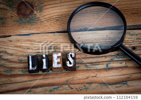 LIES. Alphabet letters on wood texture background LIES. Alphabet letters on wood texture background 112104159