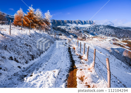 Carpathians, Romania. Winter snowy landscape with Sirnea village and Piatra Craiului mountains. 112104294