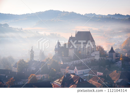 Biertan, Transylvania. Autumn sunsrise landscape with medieval saxon fortified church in Romania. Biertan, Transylvania. Autumn sunsrise landscape with medieval saxon fortified church in Romania. 112104314