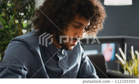 Company analyst searches for solutions to develop small business and increase profit, working on smartphone in open space office. Focused entrepreneur trying to solve task and startup issues. Company analyst searches for solutions to develop small business and increase profit, working on smartphone in open space office. Focused entrepreneur trying to solve task and startup issues. 112105505