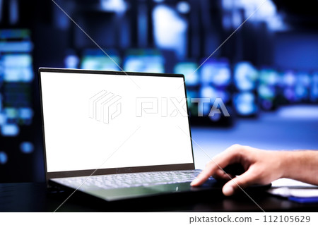 Supervisor using mock up laptop to audit server mainframes with high computing power, enabling cloud computing business to support demanding applications such as 3D rendering workloads, close up 112105629