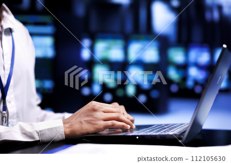Developer meticulously examining supercomputer infrastructure for power fluctuations, ensuring uninterrupted computing power. Programmer monitoring server hub, identifying potential vulnerabilities 112105630