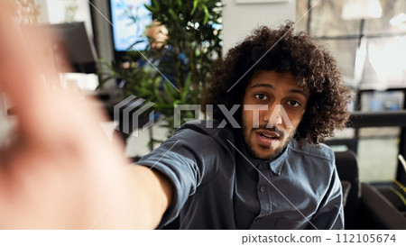 POV of manager on online videocall discussing about small business strategy, startup employee attending teleconference meeting. Middle eastern man chatting on videoconference. Handheld shot. 112105674