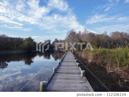 Wooden Walkway in Florida Park along Lake 112106134