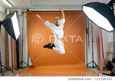 Gay man dancing in photo studio Gay man dancing in photo studio 112106383