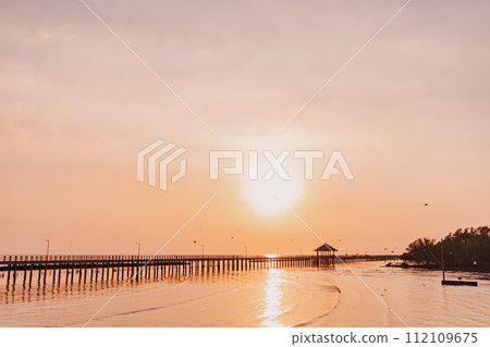 Sunset sea view seascape orange sky with long bridge. 112109675