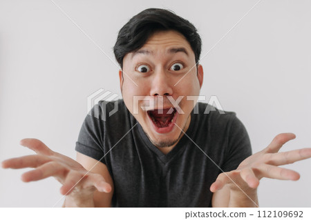 Headshot of shock face man in black t-shirt stand isolated on white. 112109692