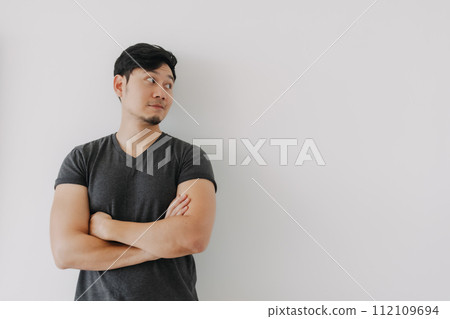 Asian man in black t-shirt crossing his arms isolated on white. 112109694