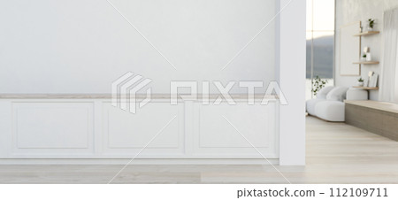 The interior design of a modern home corridor with a white wall with molding and a parquet floor. 112109711