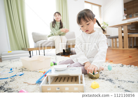 A child playing house or pretend, an image of a 3- to 4-year-old child at home, etc. A child playing house or pretend, an image of a 3- to 4-year-old child at home, etc. 112110856