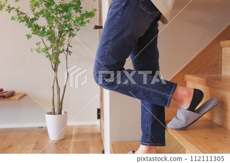 A woman descending the stairs 112111305