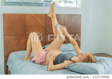 Expectant woman faces challenges while doing leg epilation during pregnancy Expectant woman faces challenges while doing leg epilation during pregnancy 112114060