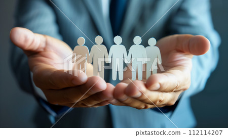 A conceptual image of a leader's hands cradling a diverse set of paper people cutouts, symbolizing inclusivity, teamwork, and community in the corporate world. A conceptual image of a leader's hands cradling a diverse set of paper people cutouts, symbolizing inclusivity, teamwork, and community in the corporate world. 112114207