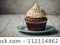 Delicious birthday cupcake on the table 112114862