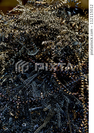 Vertical from above shot of metal shaving left after metalwork in workshop, copy space 112115012