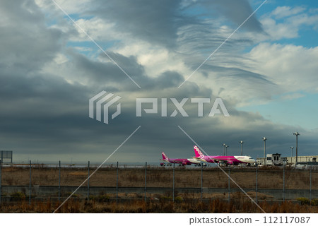 Low cost Peach Aviation planes on the runway of Kansai International Airport, artificial island in Osaka Bay Japan 18 February 2024 Low cost Peach Aviation planes on the runway of Kansai International Airport, artificial island in Osaka Bay Japan 18 February 2024 112117087